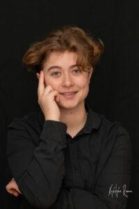 portrait d'une jeune fille les bras croisés avec une main sur la tempe photographe de portrait- krystyne ramon - home studio photos